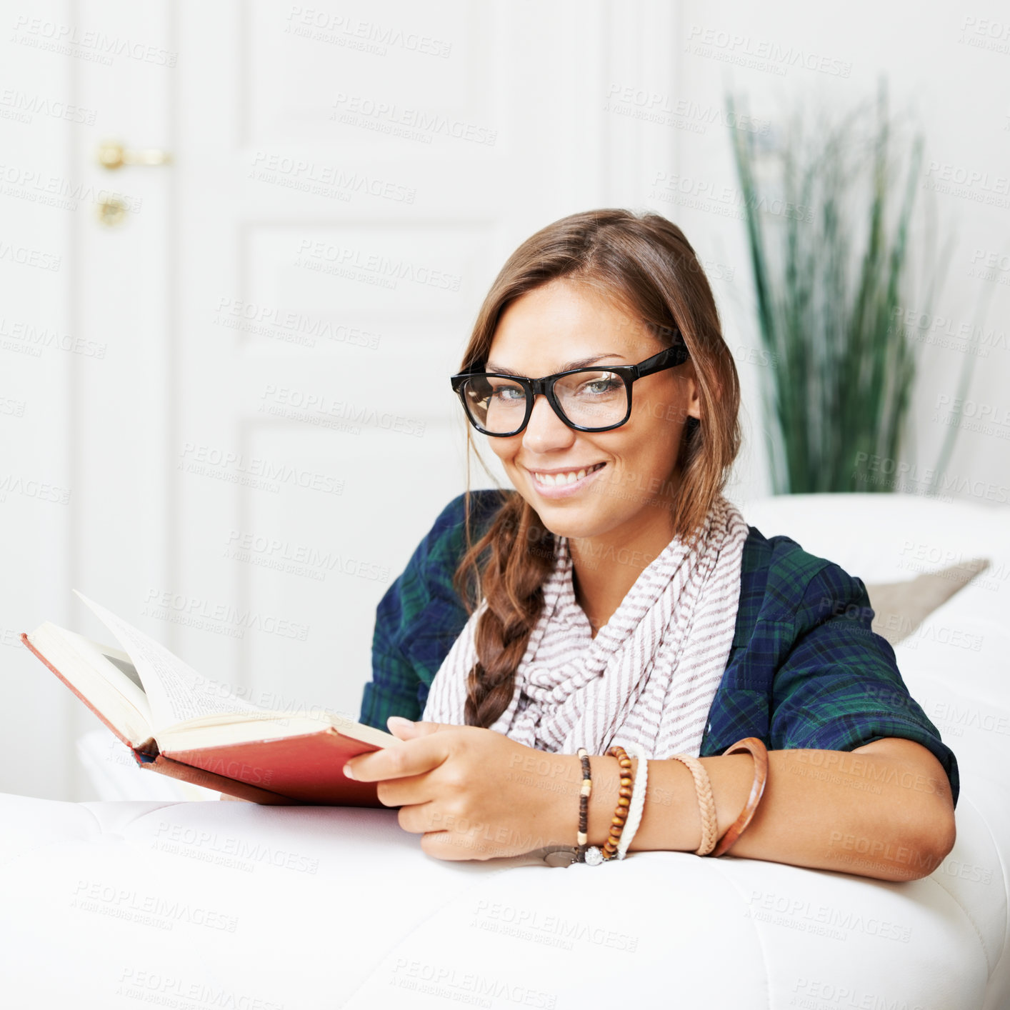 Buy stock photo Smile, portrait and woman on sofa with book, knowledge and learning with literature in home. Relax, reading and studying in apartment, happy girl in glasses on couch with story journal in living room