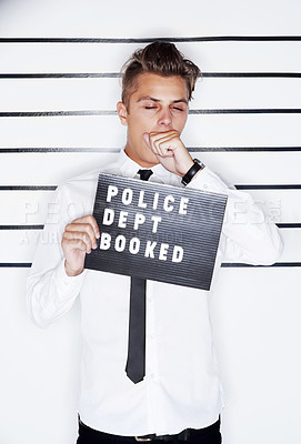 Buy stock photo Crime, mugshot and face of man on a white background for suspect for criminal, illegal or fraud activity. Police station, height chart and tired person with signboard for arrested, wanted and convict