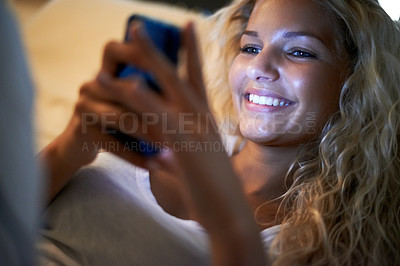 Buy stock photo Night, bedroom and woman with phone relax for social media, online chatting and text message. Networking, communication and happy person on cellphone for internet, mobile app and contact at home