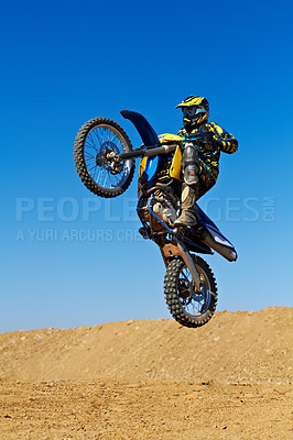 Buy stock photo Man, motorcycle or dirt bike rally as professional rider in action danger competition, fearless or race. Male person, transportation or fast mountain adventure or blue sky, challenge or driving stunt