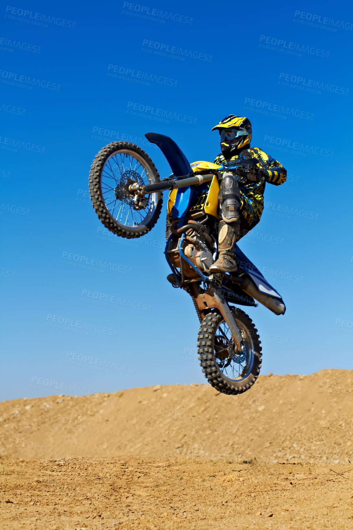 Buy stock photo Man, motorcycle or dirt bike rally as professional rider in action danger competition, fearless or race. Male person, transportation or fast mountain adventure or blue sky, challenge or driving stunt