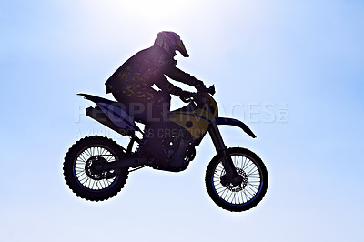 Buy stock photo Man, motorcycle or bike jump air as professional rider in danger competition, fearless or race. Male person, off road transportation or fast speed dirt adventure or rally, challenge or extreme sport