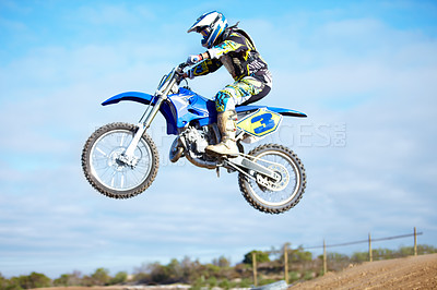 Buy stock photo A motocross rider in the air during a jump