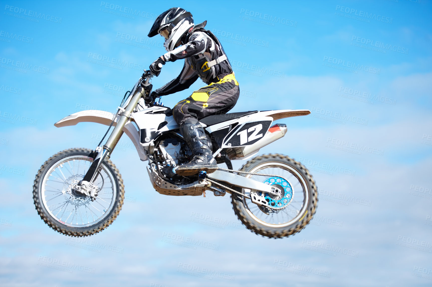 Buy stock photo Person, motorcycle and air jump in blue sky as professional in action, competition or fearless. Bike rider, off road transportation stunt or fast speed adventure at rally, extreme sport or challenge