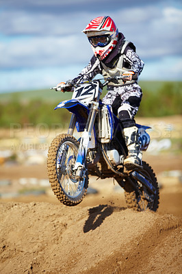 Buy stock photo Man, motorcycle and bike hill jump as professional rider in action danger competition, fearless or race. Male person, transportation or fast speed dirt adventure or rally, challenge gear or driving