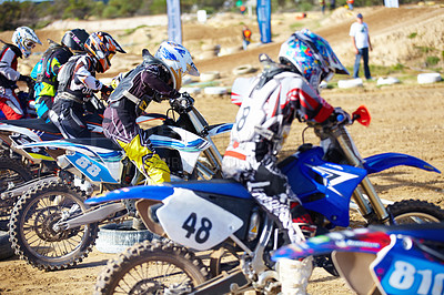 Buy stock photo Rear view of a group of motocross riders waiting for a race to start