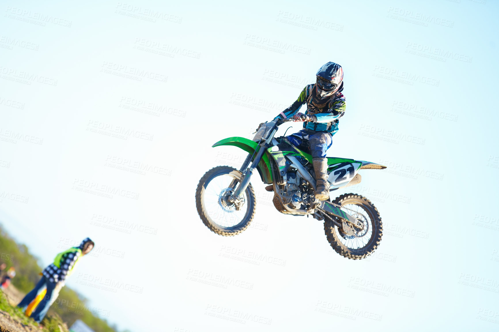 Buy stock photo Person, motorcycle and air stunt in blue sky as professional in action, competition or fearless. Bike rider, off road transportation jump or fast speed adventure at rally, outdoor challenge or race