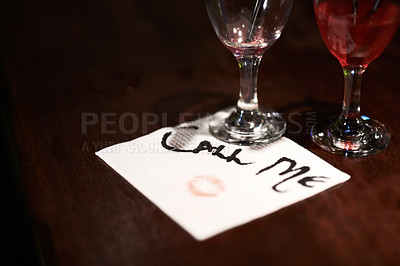 Buy stock photo Closeup of a flirtatious message written on a napkin on a bar counter