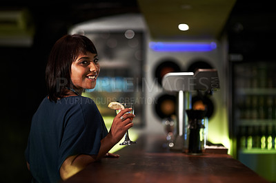 Buy stock photo Woman, smile and drink in portrait at bar, face and happy at event, party or social gathering. Female person, alcohol and cocktail for fun, relax and travel to Ibiza, dark and joy at night on face
