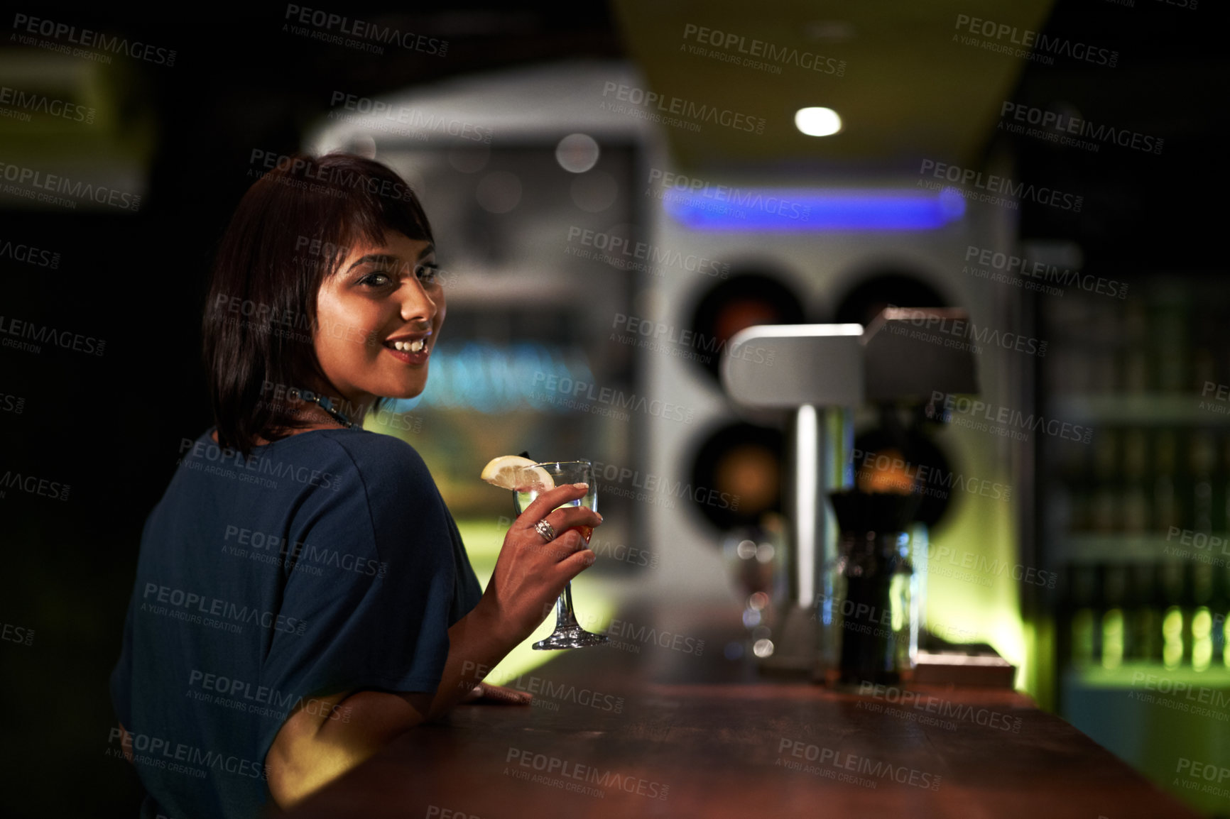 Buy stock photo Woman, smile and drink in portrait at bar, face and happy at event, party or social gathering. Female person, alcohol and cocktail for fun, relax and travel to Ibiza, dark and joy at night on face