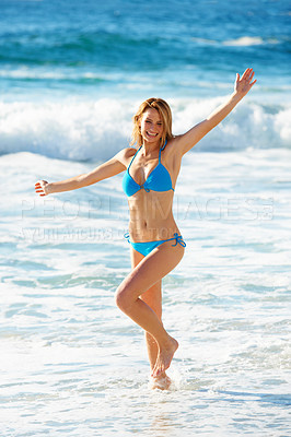 Buy stock photo Portrait of a gorgeous young woman dancing in the ocean