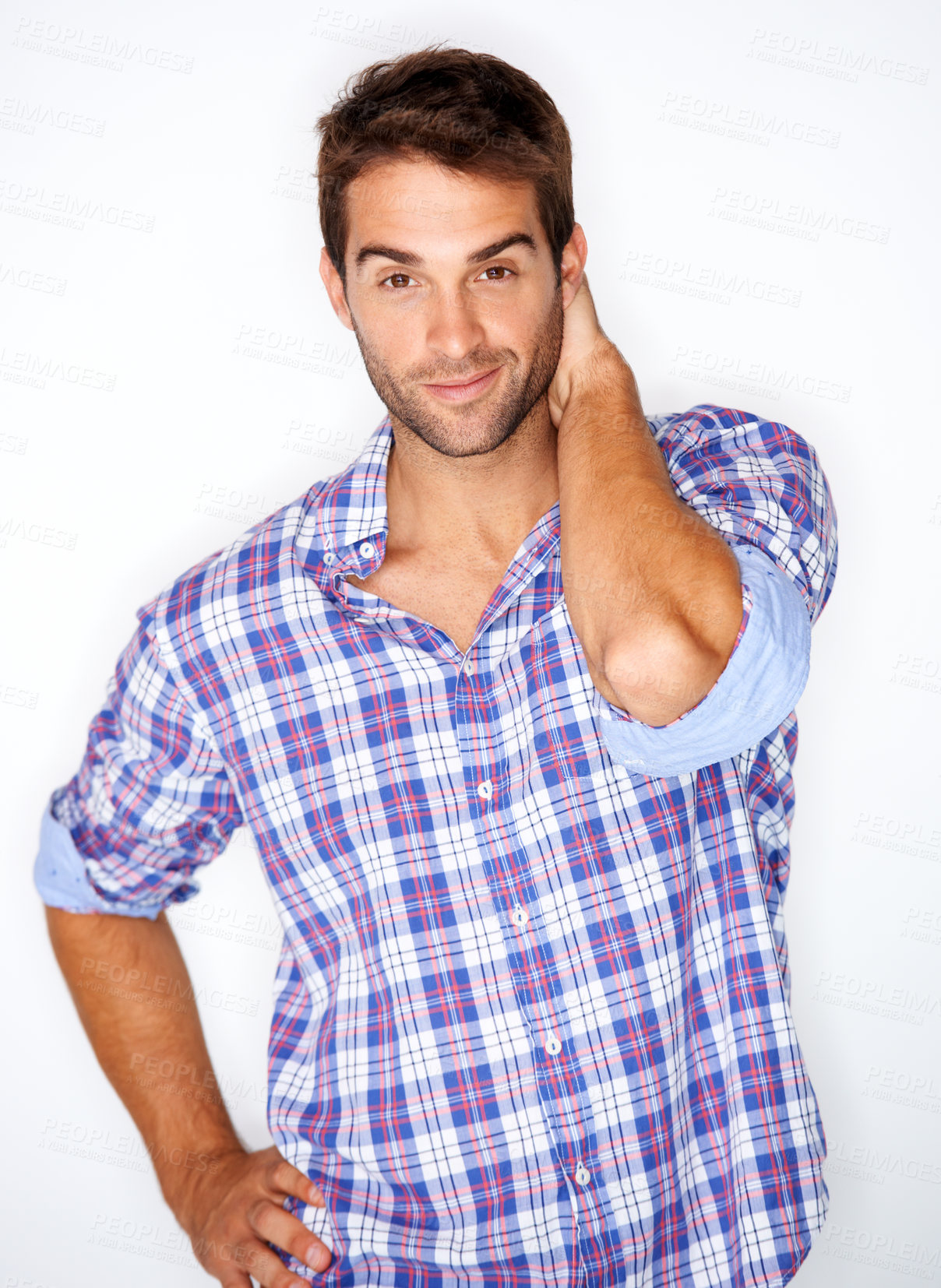 Buy stock photo Handsome young guy in a check shirt with his hand behind his head against a white background