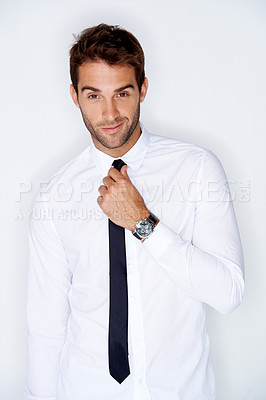 Buy stock photo Portrait, fashion and a business man getting ready for corporate work in studio on a white background. Face, shirt and tie with a confident young employee dressing in a professional clothes outfit