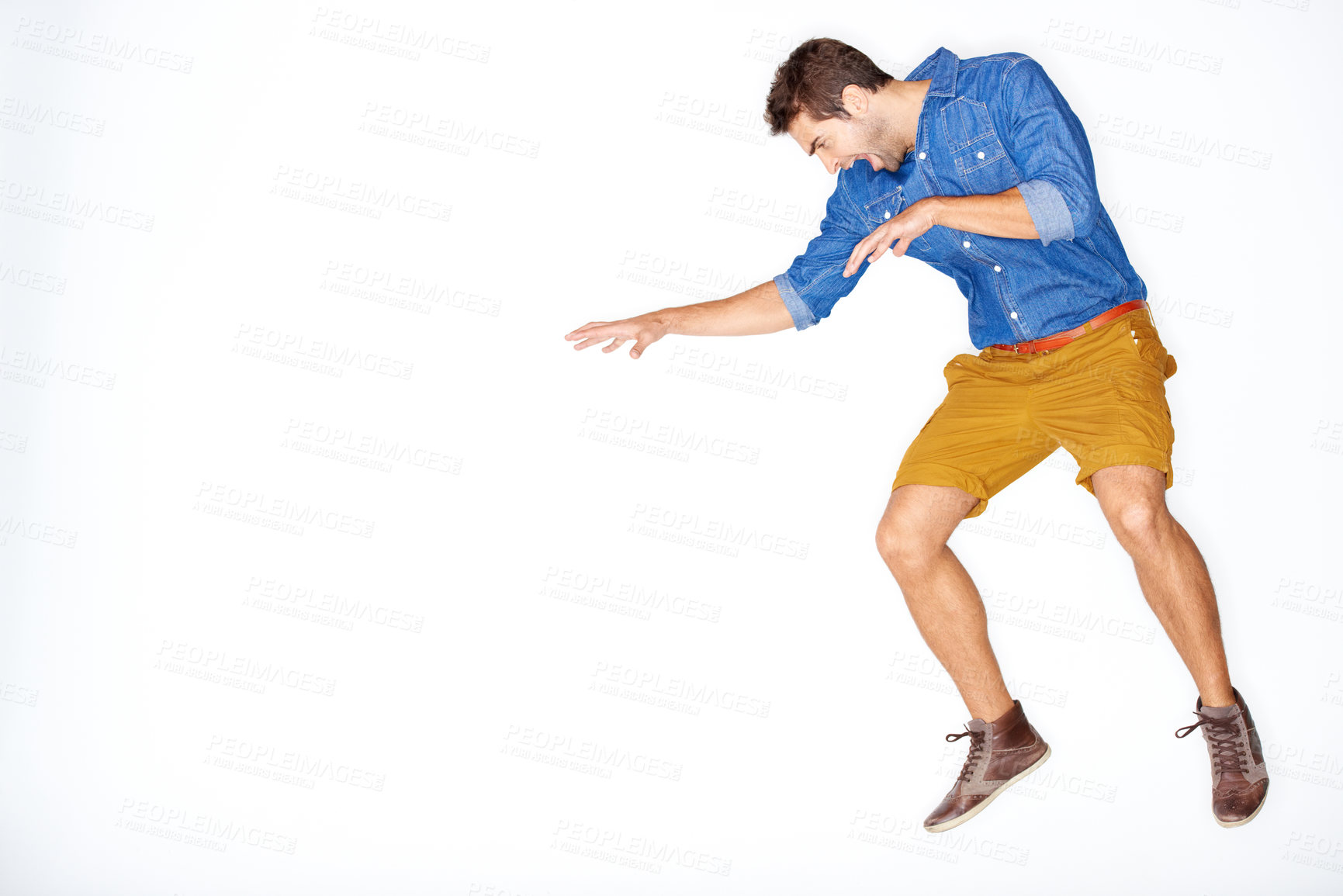 Buy stock photo Jump, fight and a man on a white background for attack, aggressive or angry with mockup space. Anger, studio and a frustrated, crazy or screaming guy or person with mental health on a backdrop