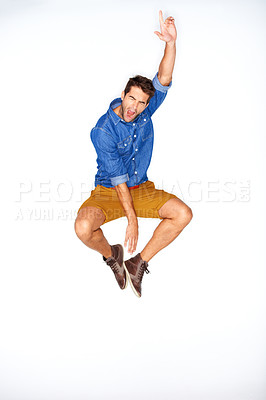 Buy stock photo Jump, fashion and energy with a man shouting in studio on a white background for trendy hipster fashion. Success, winner and scream for motivation with a young model leaping in a clothes outfit
