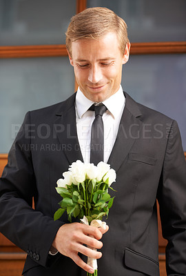 Buy stock photo Love, romantic and man with flowers for valentines day, romance or gesture while standing against a wall background. Roses, happy and gentleman with bouquet for sweet, anniversary gift or first date 