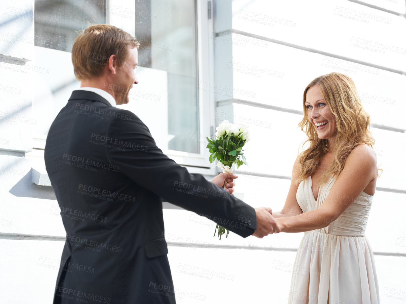 Buy stock photo Man, flowers and woman with smile for valentines day, relationship or celebration for date. Happy couple holding hands with white roses or bouquet to celebrate anniversary or special month of love