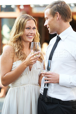 Buy stock photo Wine, love and couple at a party, smile and happy while talking, flirting and bonding at an outdoor event. Champagne, romance and man with woman in romantic moment, first date or valentines day