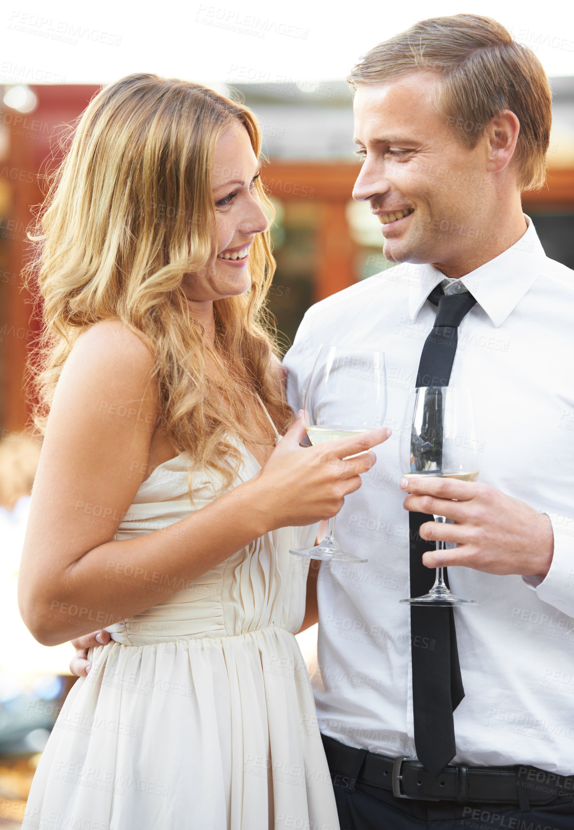 Buy stock photo Love, wine and couple at a party, smile and happy while talking, flirting and bonding at outdoor event. Champagne, romance and man with woman in romantic moment, cheerful on first date or anniversary
