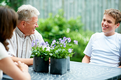 Buy stock photo Grandparents, boy and outdoor with smile, backyard and home with family, teenager and garden. Retired, man and woman with conversation, happiness and child for bonding together, support and relax