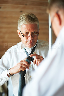 Buy stock photo Mature man with mirror, tie and shirt for work in morning in apartment with glasses, clothes and confidence. Face, reflection and professional senior businessman in home getting ready for office.