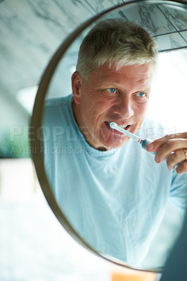 Buy stock photo Mirror, cleaning or mature man brushing teeth with dental toothpaste for oral hygiene grooming in home. Face reflection, morning or senior person with a toothbrush for care, wellness or healthy mouth