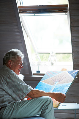 Buy stock photo Man, artist or holding painting with pride in bedroom and happy elderly guy by window for creative art. Mature painter, design or retirement for watercolor drawing on canvas, talent artwork at home