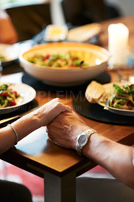 Buy stock photo Holding hands, home or couple praying for food or support at a dinner table together to celebrate. Christian religion, God or closeup of spiritual people eating lunch with faith, hope or gratitude 