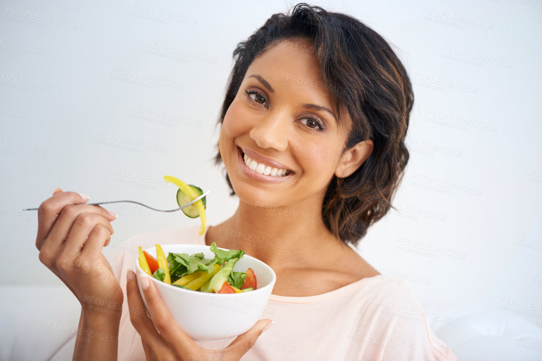 Buy stock photo Portrait of a young woman enjoying a salad at home