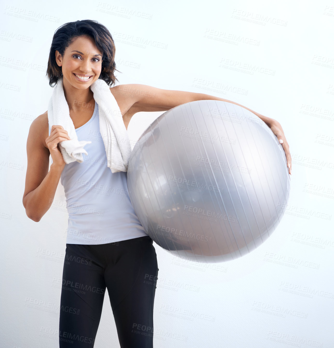 Buy stock photo Black woman, exercise ball and smile in studio for fitness, training or workout with towel on white background. Person, portrait and happiness with equipment for wellness, pilates or yoga on mock up
