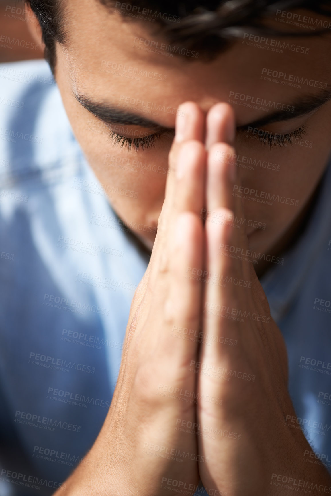 Buy stock photo Closeup of a young man praying with his hands together