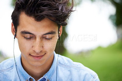 Buy stock photo A handsome young man enjoying his music