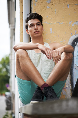 Buy stock photo Man, relax and thinking or chilling, wall and outdoors for fashion, cool and trendy or stylish for confidence. Filipino male person, calm and resting on vacation, holiday and travelling to Mexico