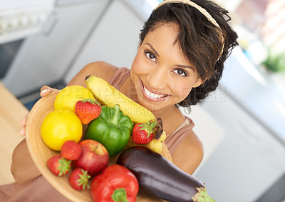 Buy stock photo Portrait of a young woman holding a bowl full of fresh produce