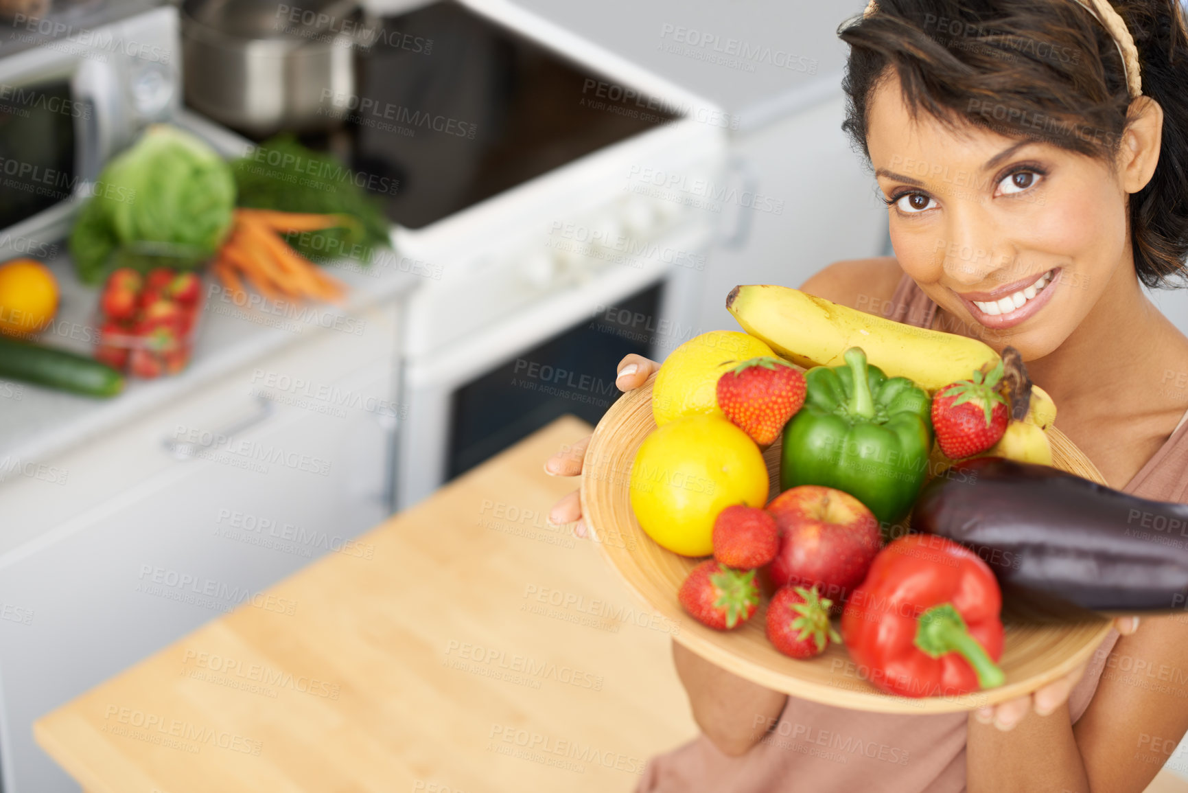 Buy stock photo Portrait, space and vegetables with a woman in the kitchen of her home for nutrition, diet or meal preparation. Face, smile and a recipe for cooking healthy food with a young person in her apartment