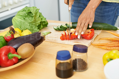 Buy stock photo Woman, hands and cutting tomato in kitchen on wooden board for healthy diet or vegetarian meal at home. Closeup of female person slicing natural organic red vegetable for salad preparation at house