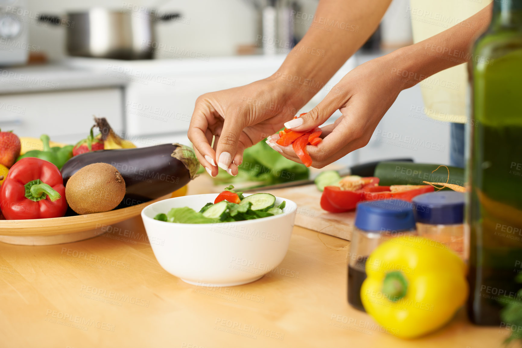 Buy stock photo Hands, cooking and salad with a person in the kitchen of a home closeup for health, diet or nutrition. Food, bowl and ingredients for a vegetarian meal with an adult in an apartment for dinner