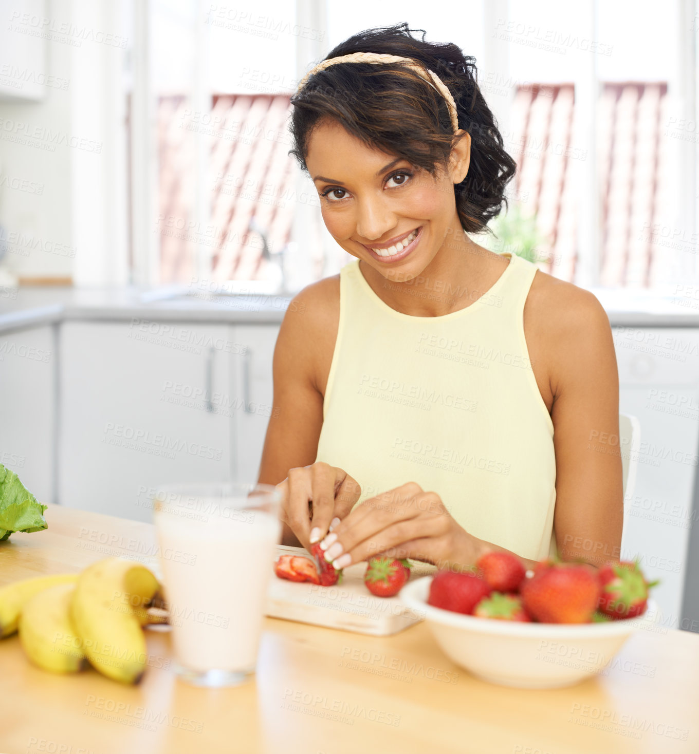 Buy stock photo Portrait, strawberry and fruit salad with a woman in the kitchen of her home for health, diet or nutrition. Smile, food and weight loss with a young person in her apartment for meal preparation