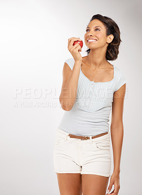 Buy stock photo Health, apple and young woman in a studio for wellness, nutrition or organic weight loss diet. Smile, vitamins and female person from Mexico eating a fruit for healthy vegan snack by white background