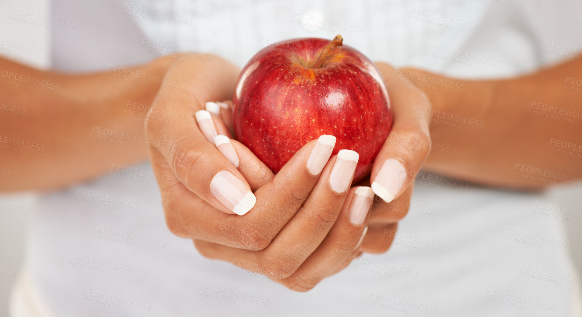 Buy stock photo Hands, apple or fruit with a person closeup for health, diet or nutrition in the kitchen of her home. Food, nutritionist and hunger with an adult eating fresh produce for a healthy weight loss snack