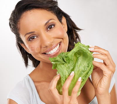 Buy stock photo Happy woman, portrait and lettuce for healthy diet, vegetables or snack against a studio background. Face of female person smile with green leaves for natural nutrition, fiber or health and wellness