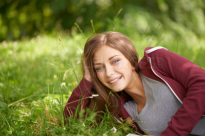 Buy stock photo Portrait, grass and woman relax in field with smile, happy and park on summer weekend outdoors. Nature, countryside and person sitting in meadow for calm, peace and fresh air on holiday or vacation