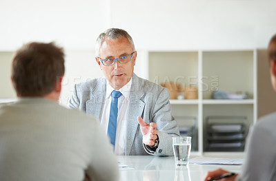 Buy stock photo Meeting, people and mature lawyer with advice in office for legal consulting and feedback for clients, Businessman, talking and attorney in negotiation debate and professional advocate in law firm