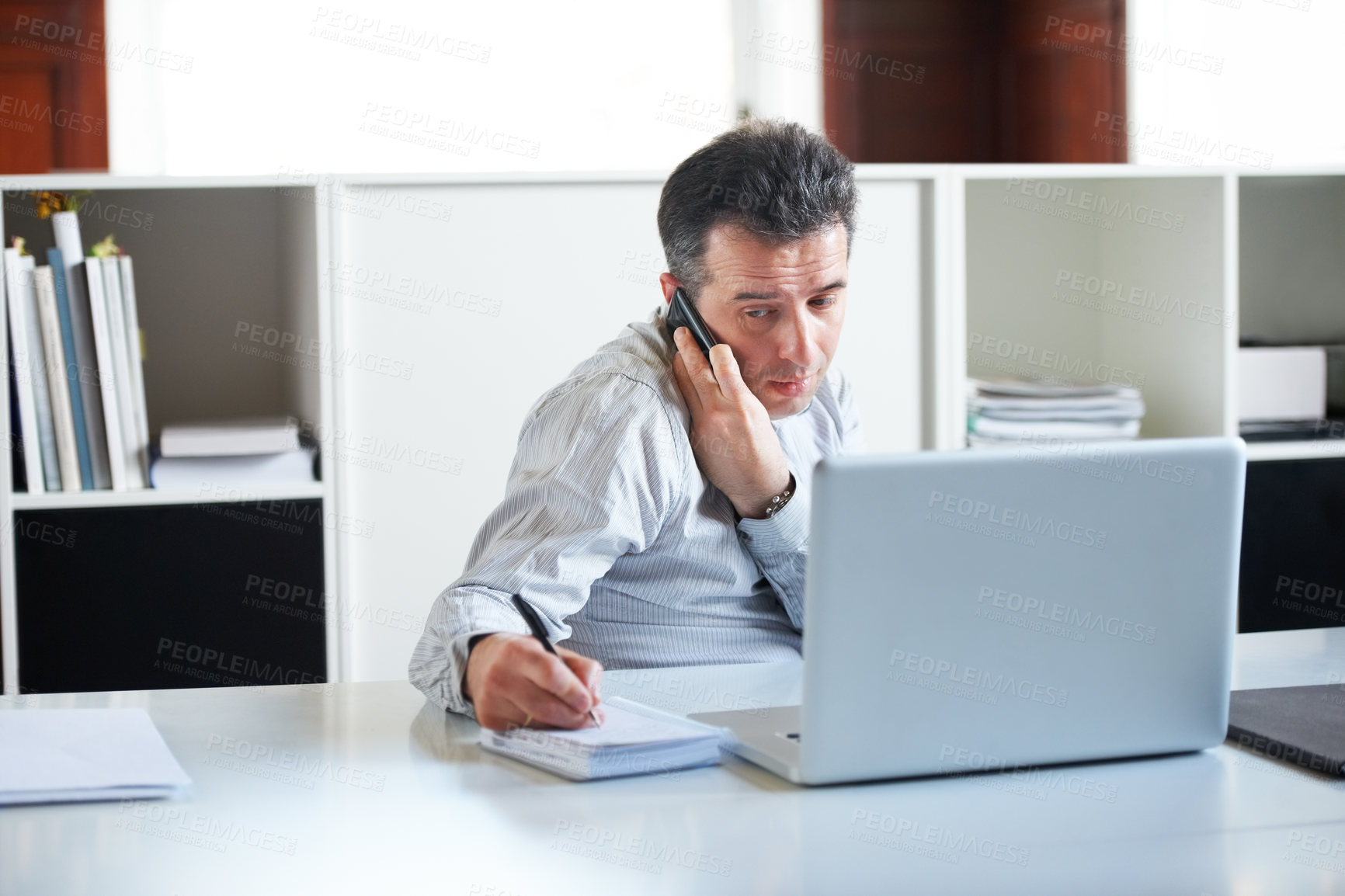 Buy stock photo Consultant, businessman with smartphone on a call and with laptop writing notes in a notebook at his office. Customer service or online communication, networking and male person a cellphone at desk