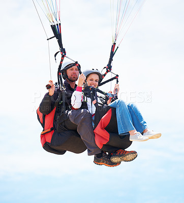 Buy stock photo Portrait of two people doing tandem paragliding in mid-air