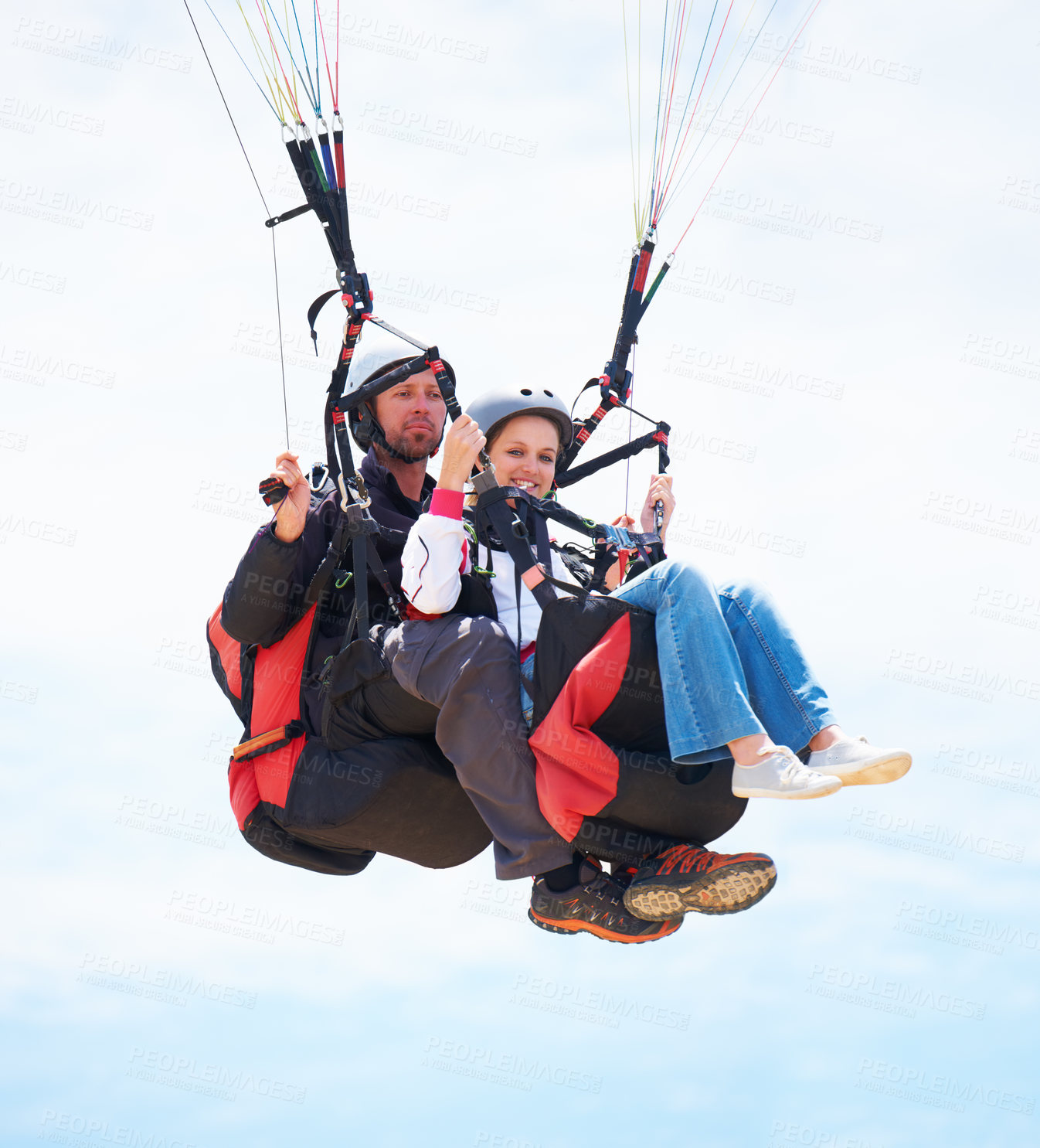 Buy stock photo Portrait of two people doing tandem paragliding in mid-air