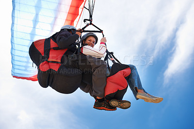 Buy stock photo People, paragliding and freedom in sky, together or extreme sport with smile for fitness. Coach, partnership and person on adventure, helmet or fearless with backpack, parachute or flight in portrait