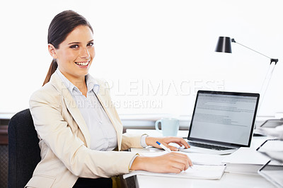 Buy stock photo Portrait of a young businesswoman sitting at a desk in an office