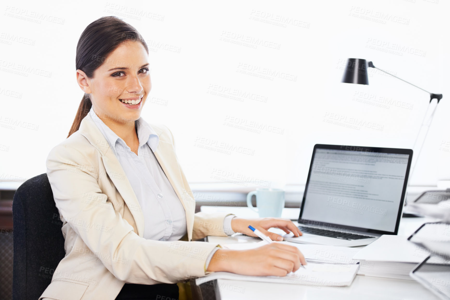Buy stock photo Portrait of a young businesswoman sitting at a desk in an office