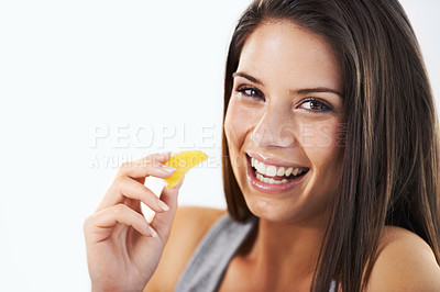 Buy stock photo Woman, portrait and eating tangerine in studio for nutrition, healthy vegan diet or clean detox on white background. Face of happy model with orange fruits, citrus food or lose weight on mockup space
